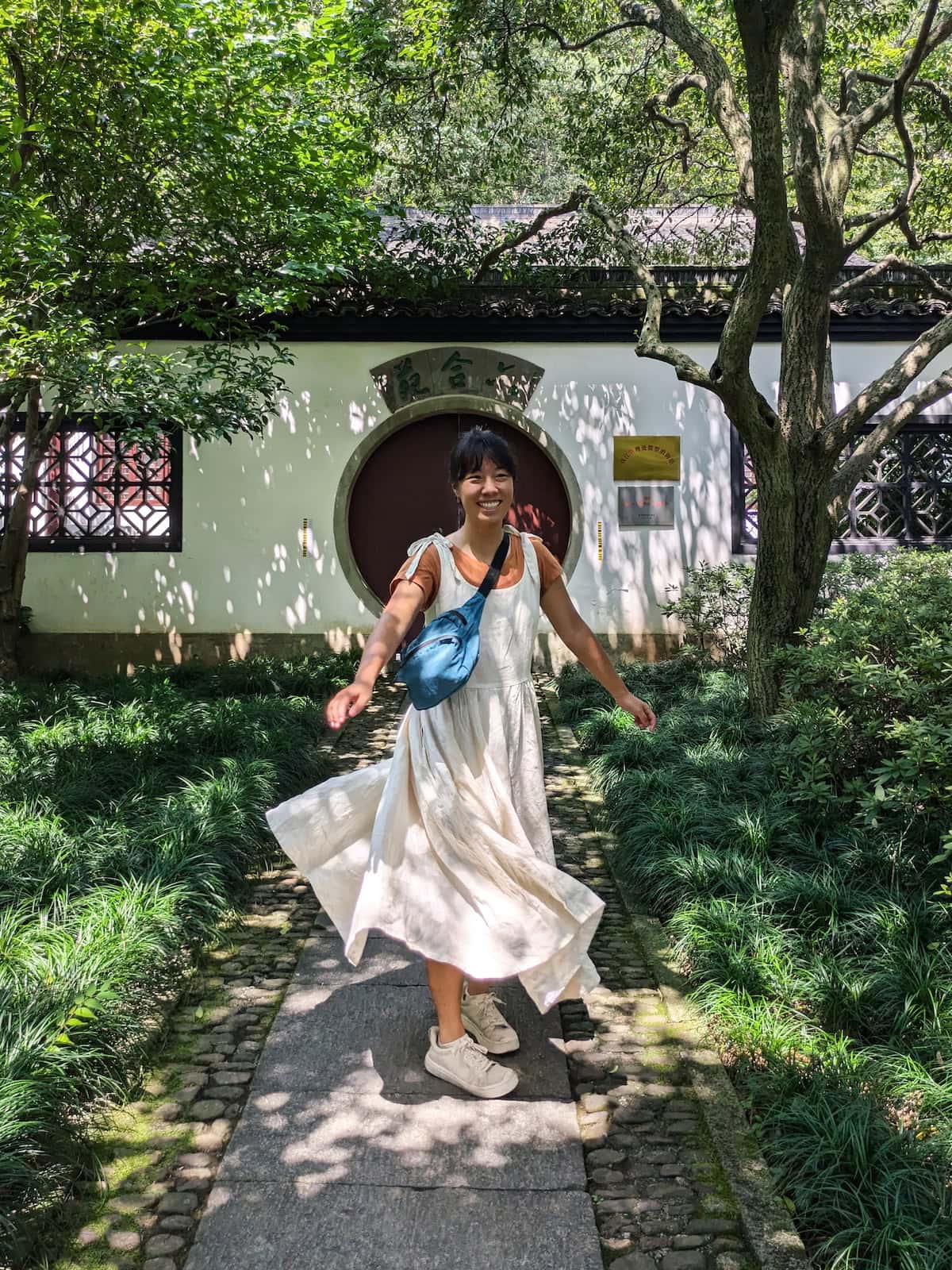 Me wearing a white linen dress with shoulder ties (Amelia Dress by Son de Flor in Milky White)