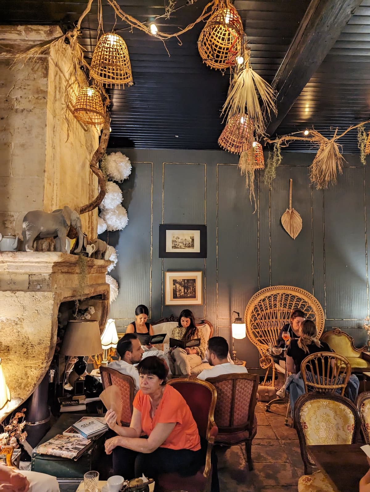 Interior of La Diplomate with wicker chairs and hanging lamps