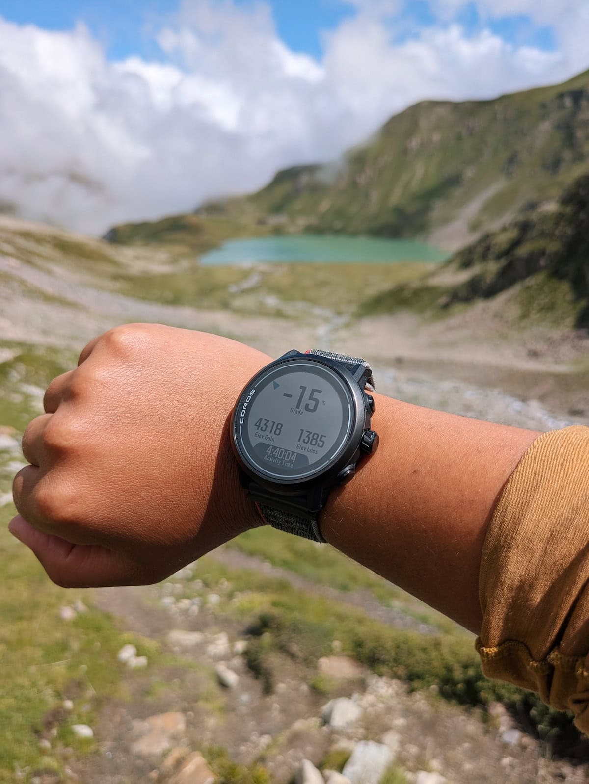 My COROS APEX 2 on my multi-day hike with a mountain lake in the background