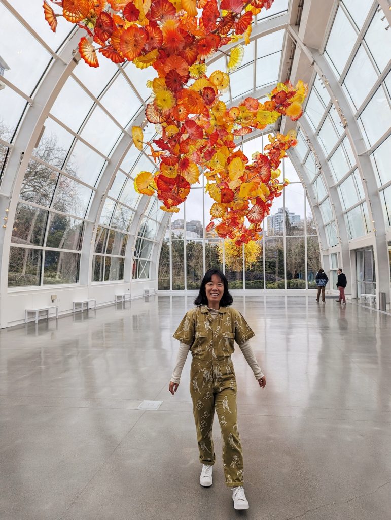Me wearing an abstract jumpsuit at Chihuly Garden and Glass