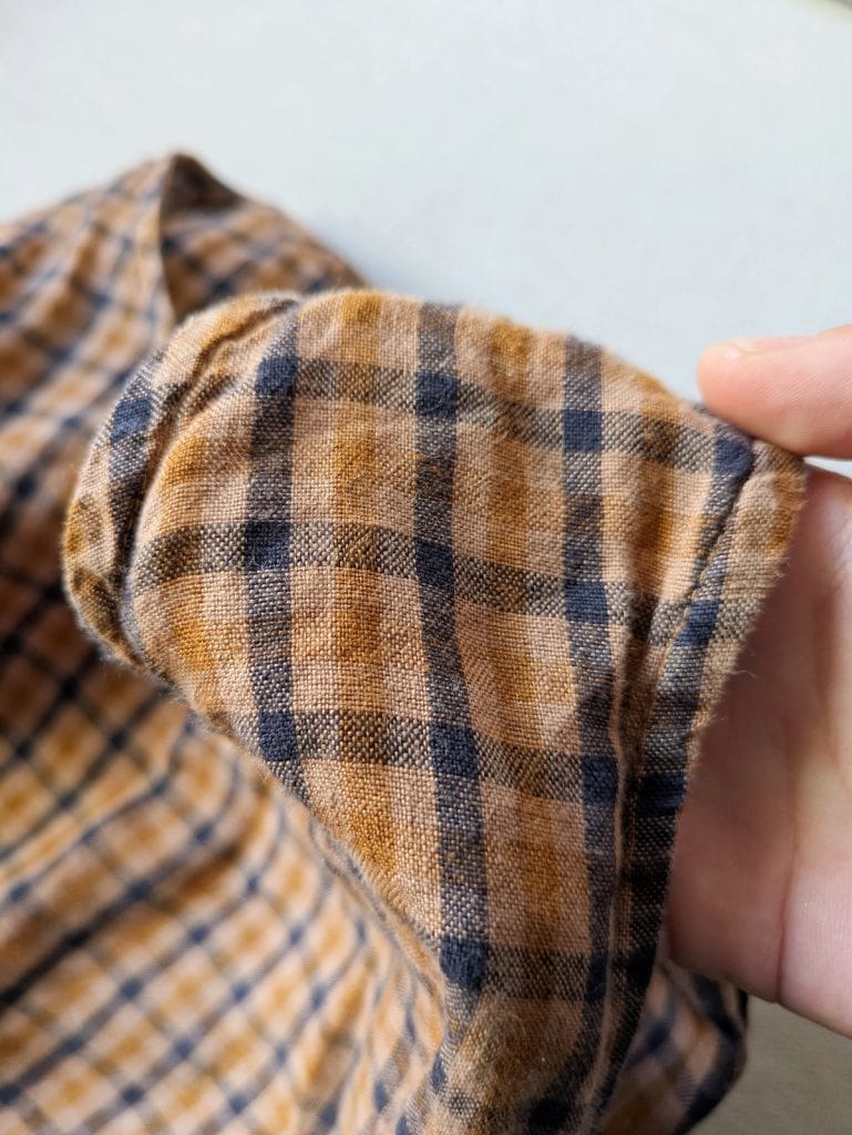 Closeup of the fabric on the Son de Flor brown tartan smock dress