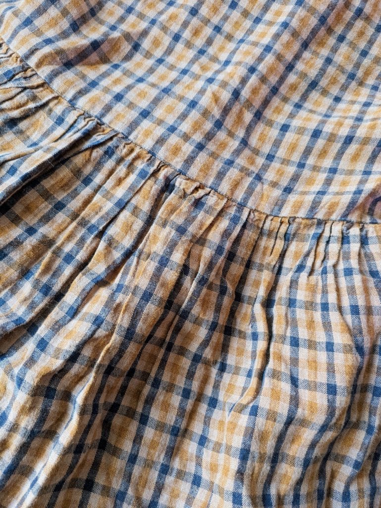 Closeup of the fabric on the Son de Flor brown tartan smock dress