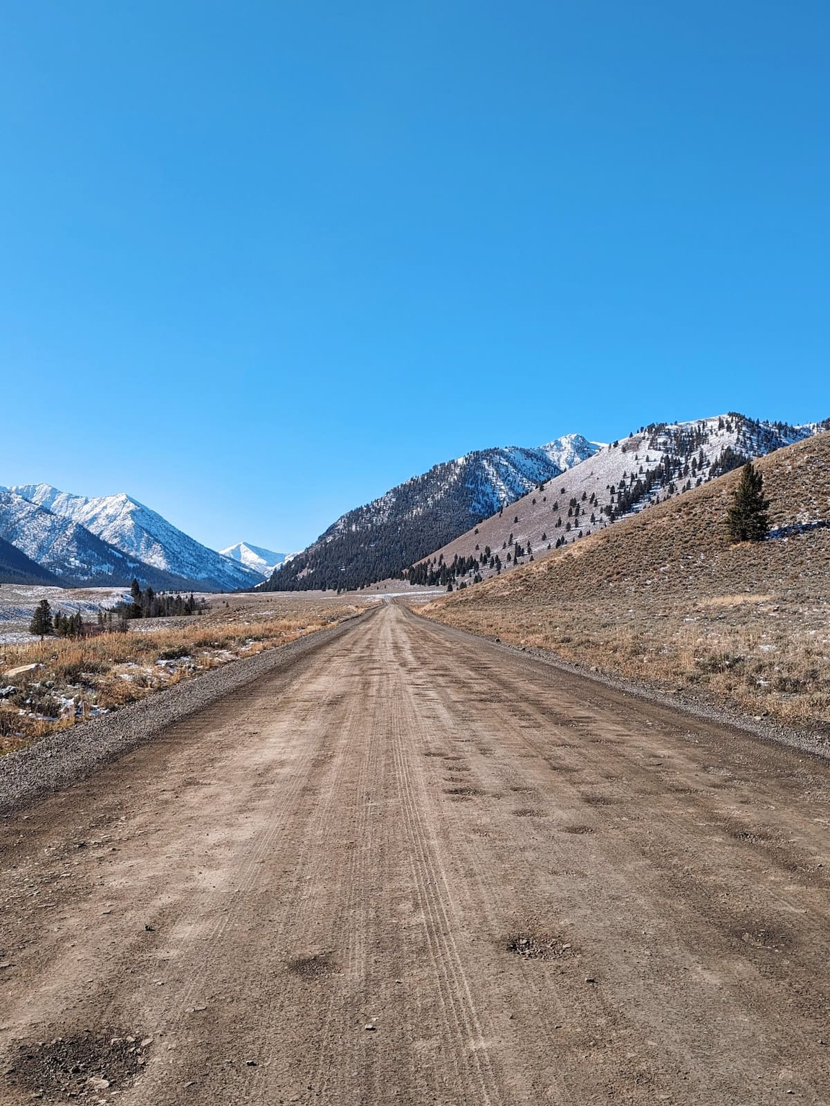 The potholes on Trail Creek Road with mountains in the distance