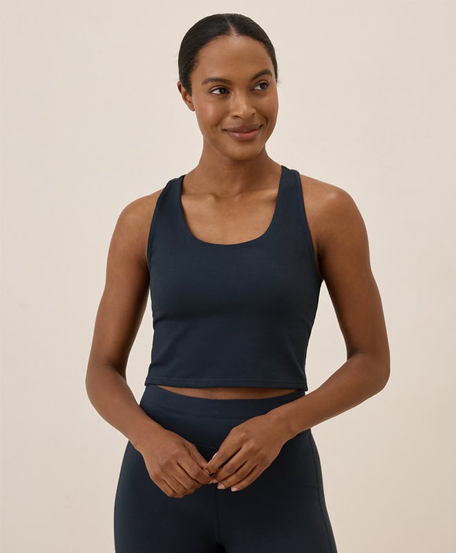 Black woman wearing a navy crop tank