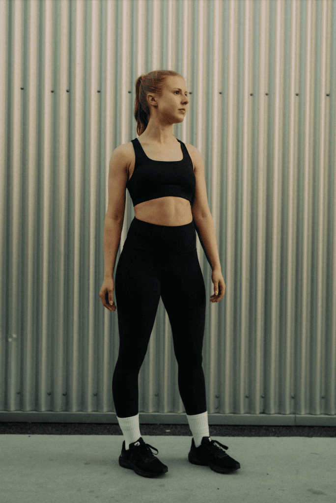 Woman wearing black sports bra and leggings