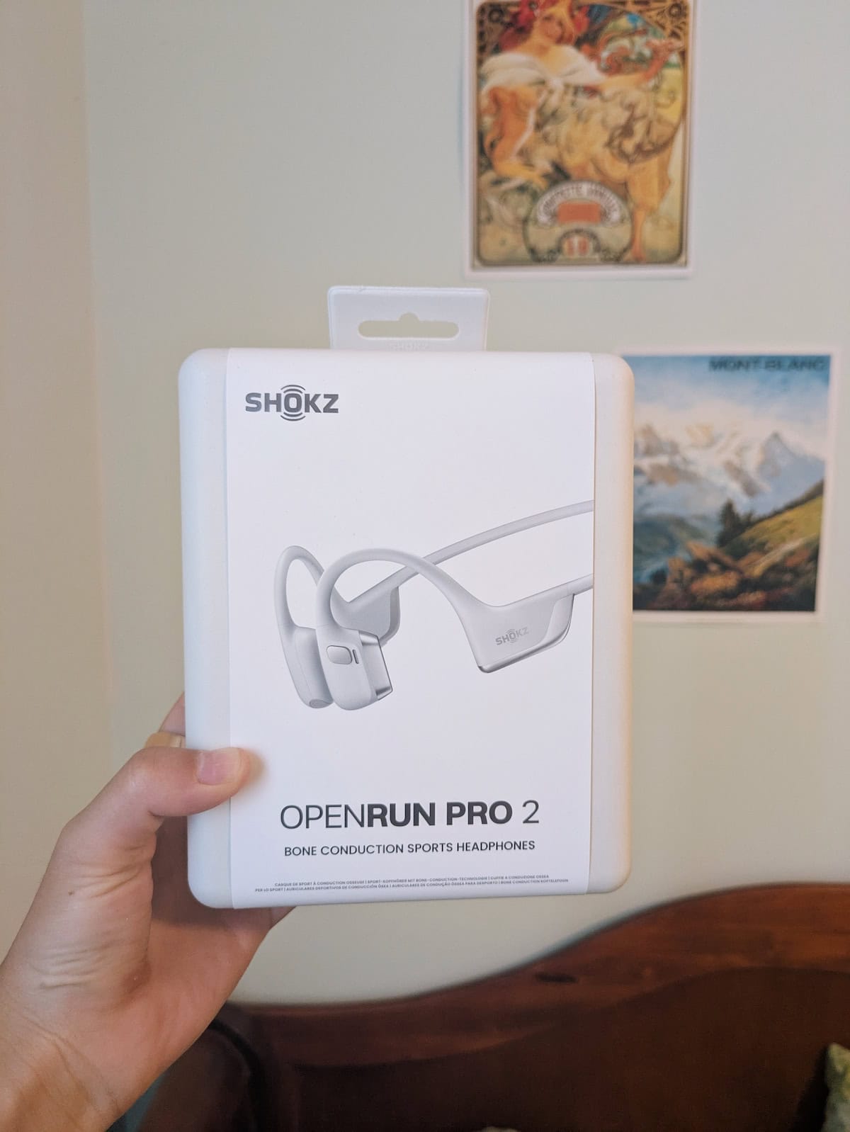 Holding the box of the Shokz OpenRun Pro 2