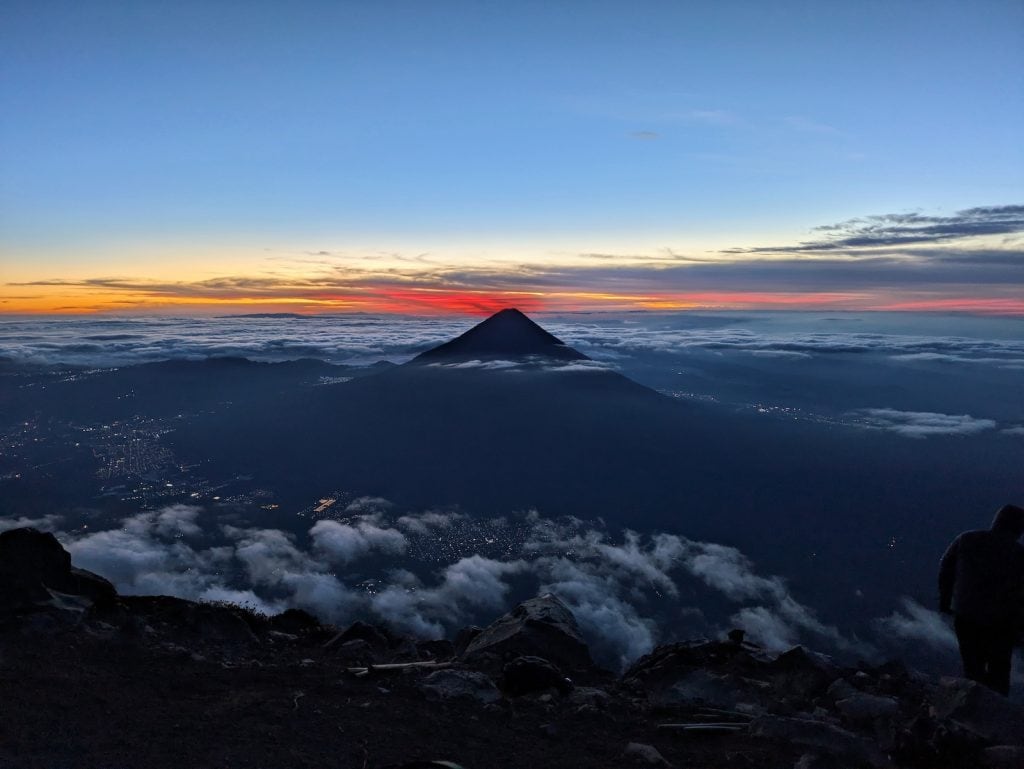 Agua Volcano at sunrise surrounded by clouds