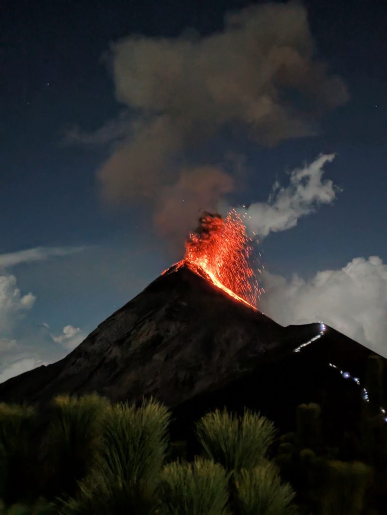 Fuego Volcano erupting at night with lava