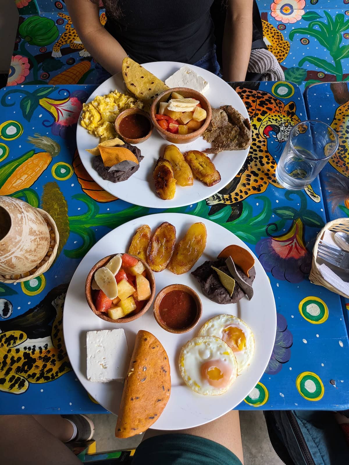 Typical Guatemalan breakfast with beans, fruit, plantains, eggs, and cheese