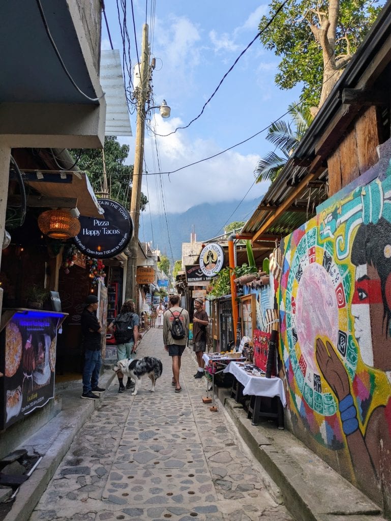A street in San Marcos la Laguna with colorful murals and shops