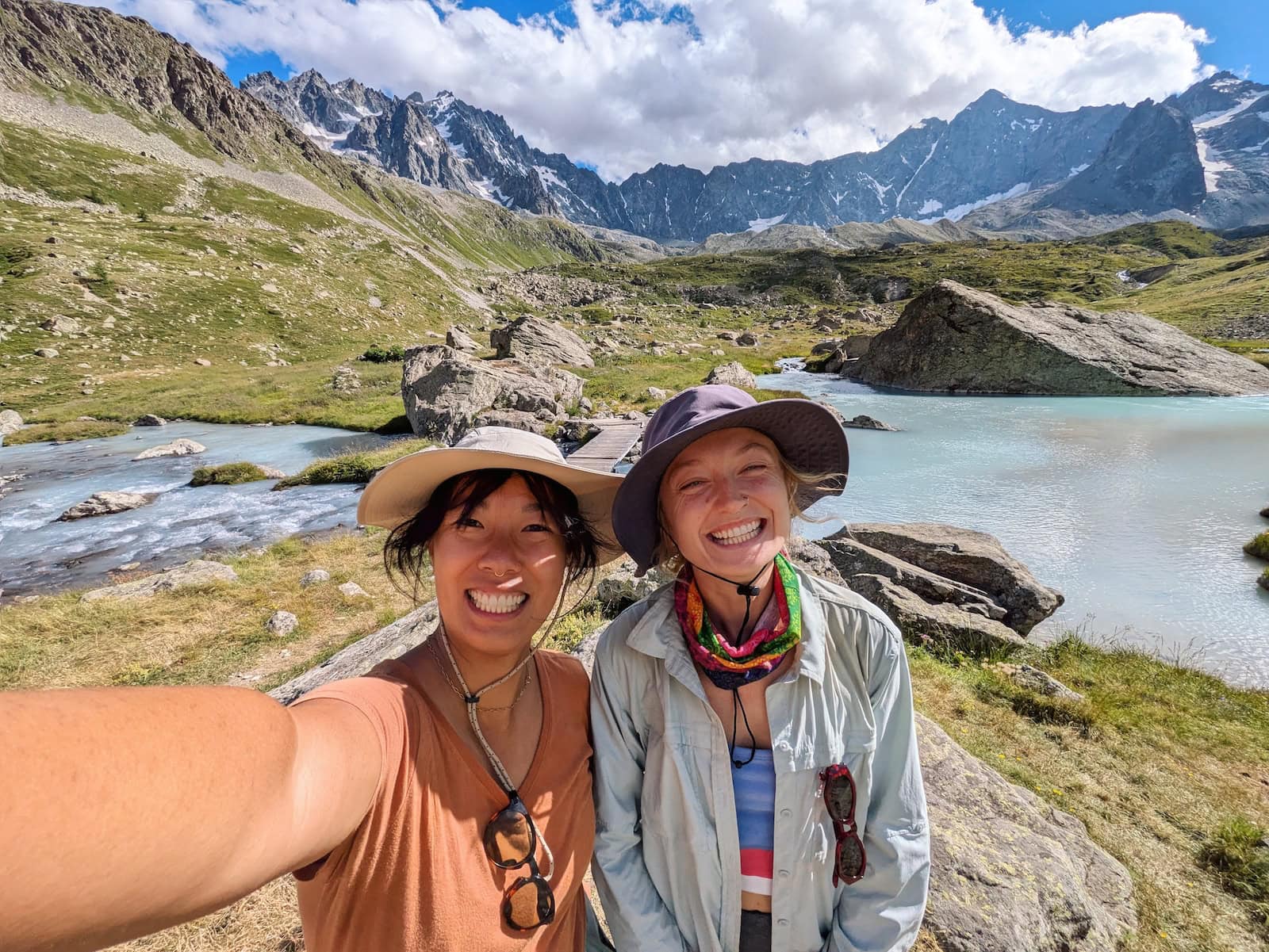 Me and Tessa taking a selfie at a milky blue lake with glaciers in the background
