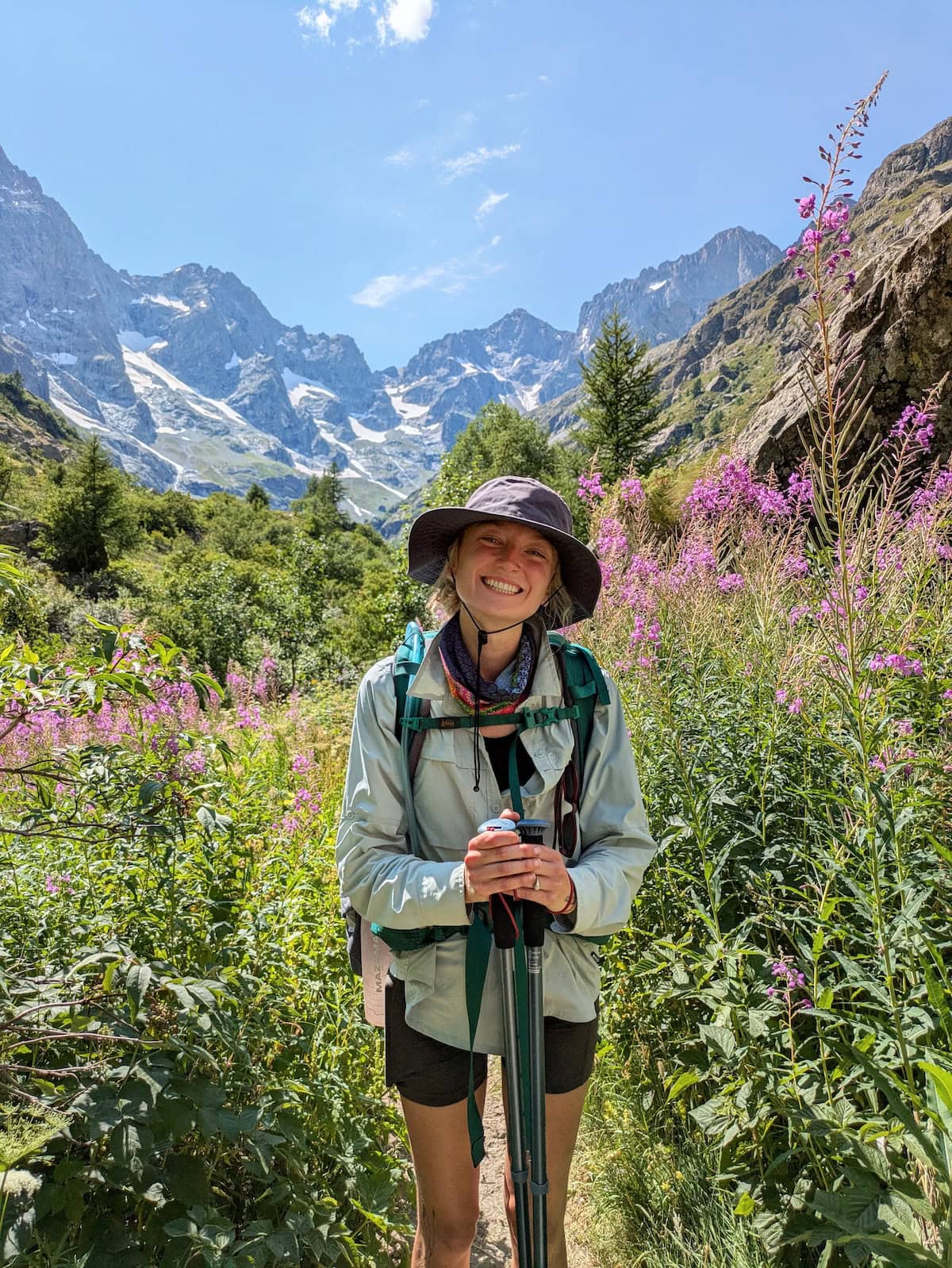 Tessa posing in flowers with glaciers in the distance