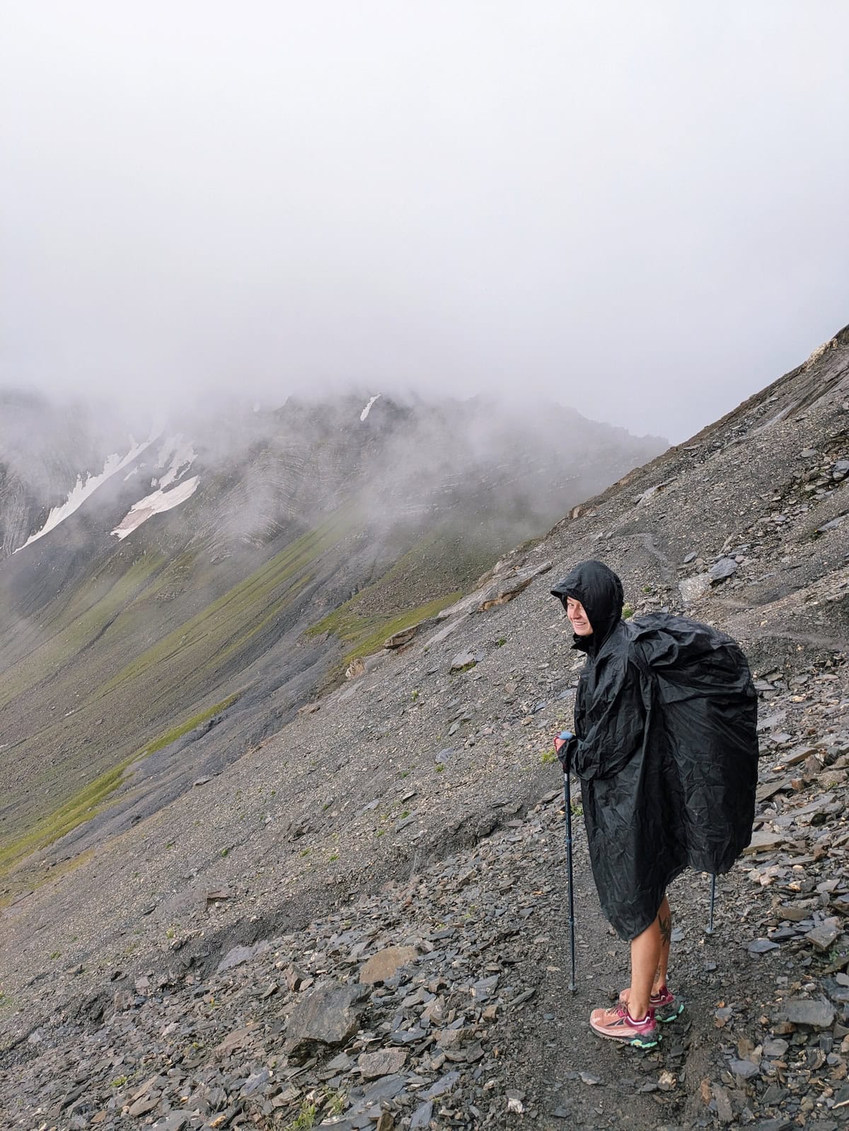 The thick mist at Col de l'Aup Martin. Tessa poses with her poncho that covers her backpack