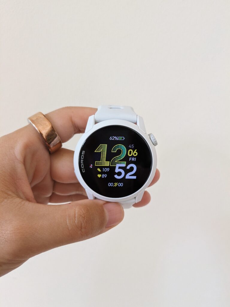 COROS PACE 4 in white in my hand on the home screen