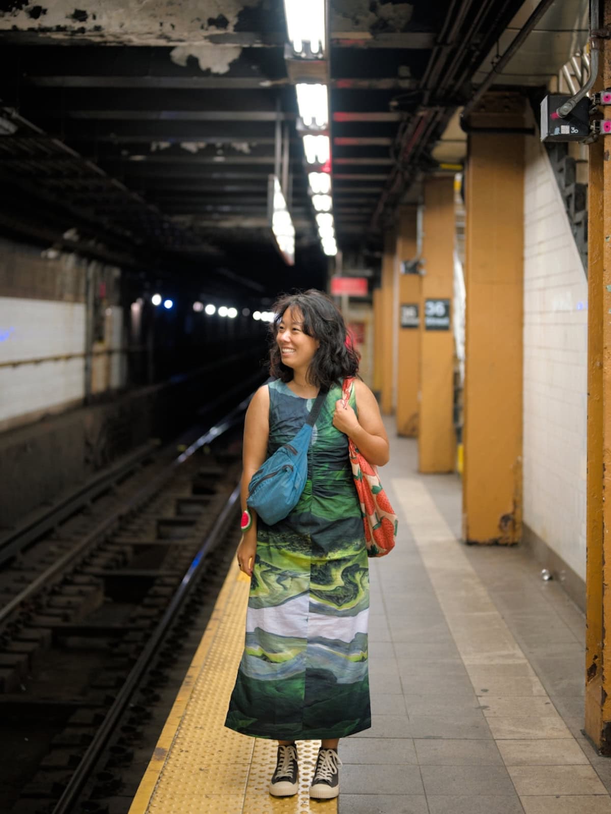 Me wearing an abstract green dress in the NYC subway