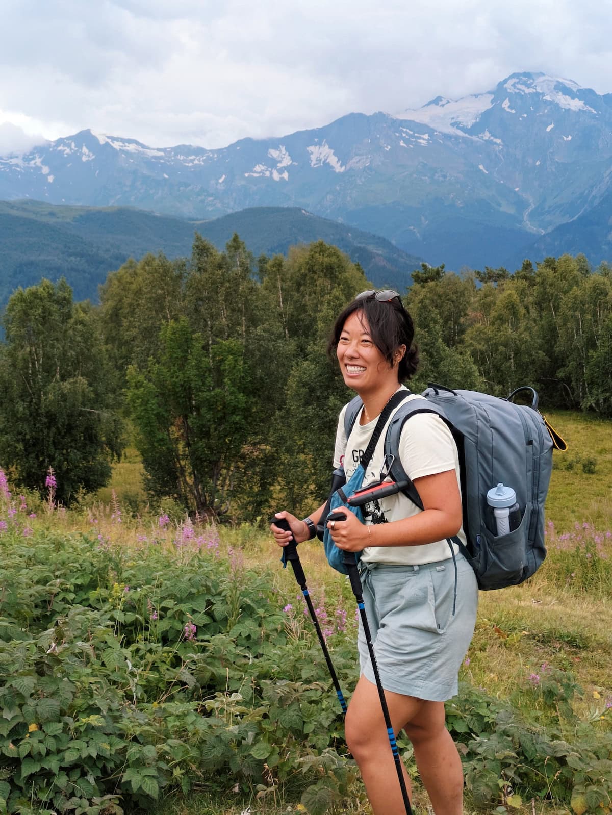 Me hiking with snow-capped mountains in the background