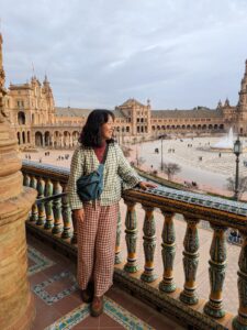Me wearing a gingham set while looking out at Plaza de España in Sevilla