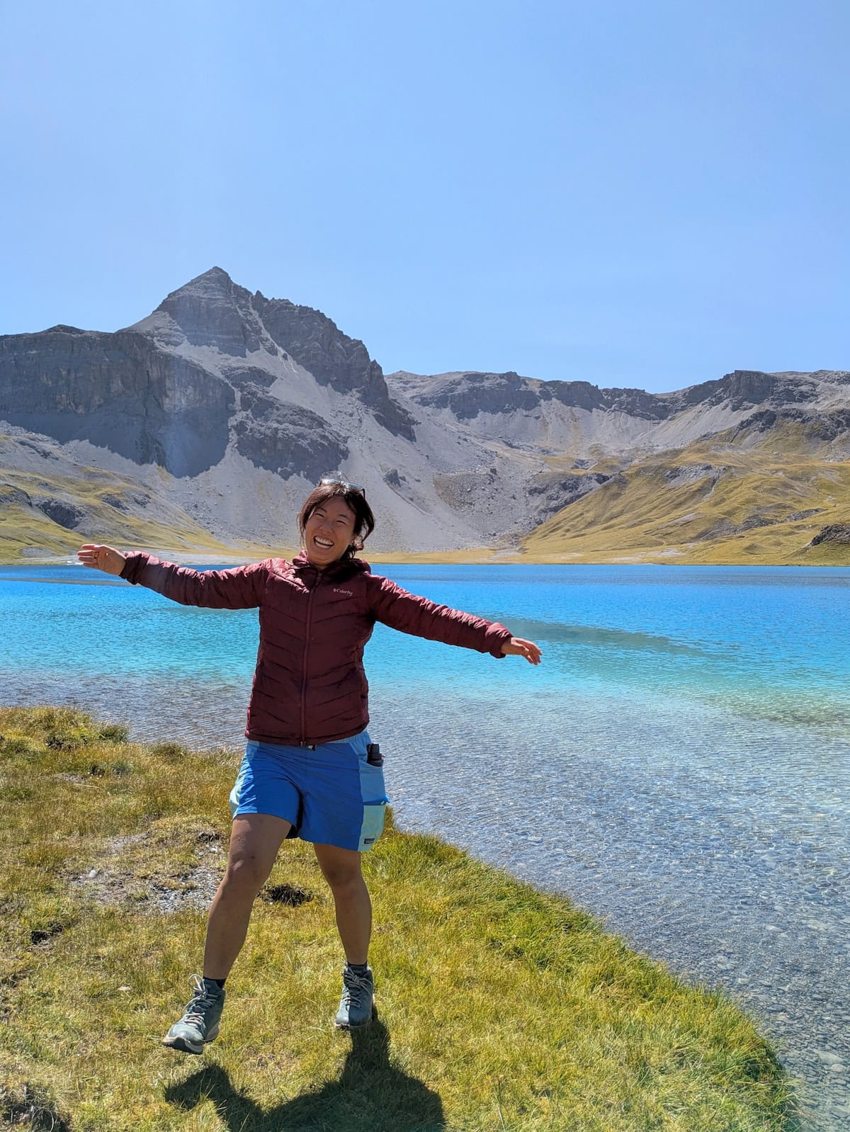 Me jumping near a mountain lake