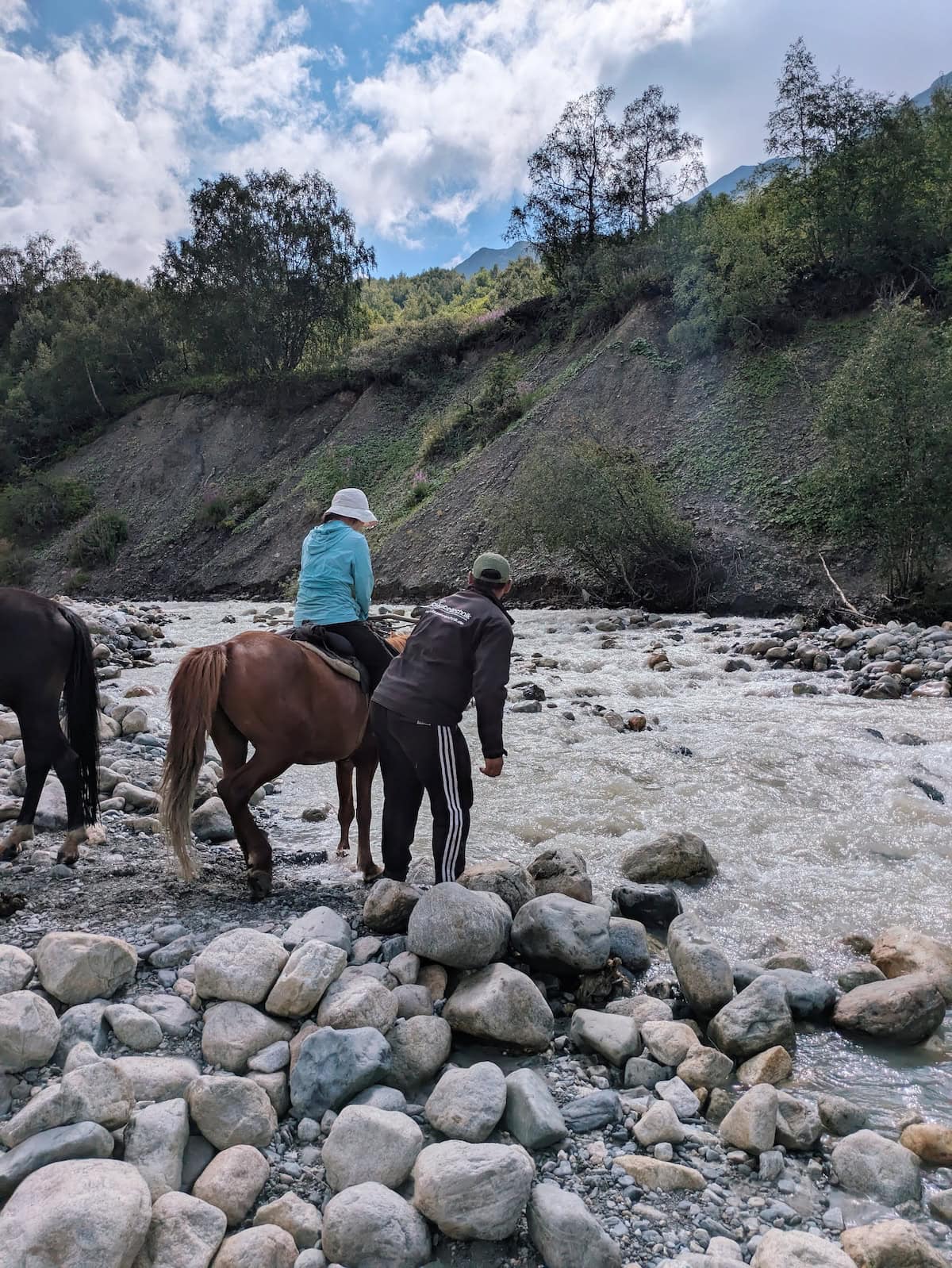 Photo of horse crossing the river near Adishi Glacier