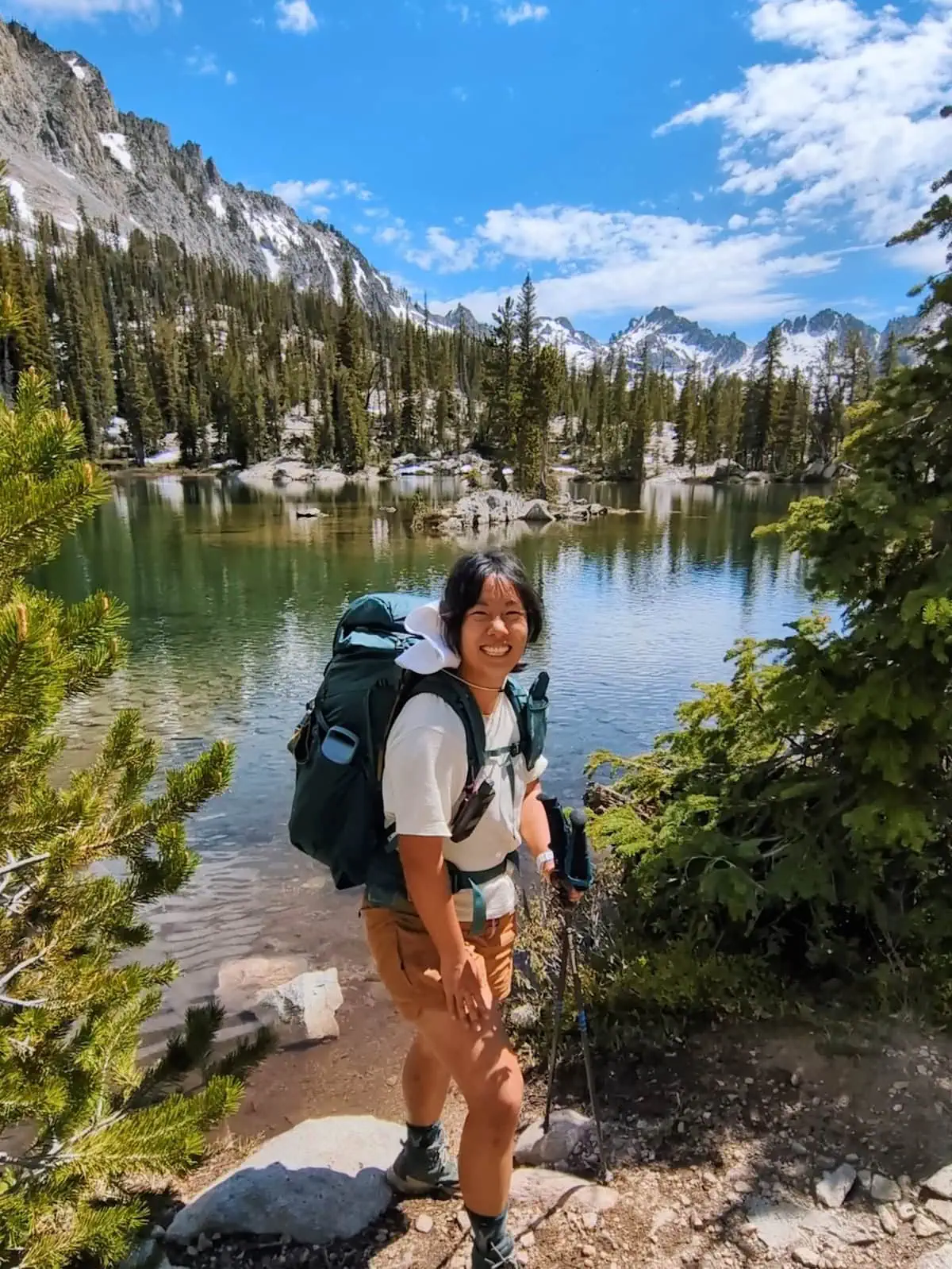 Me standing in front of Alice Lake with backpacking gear