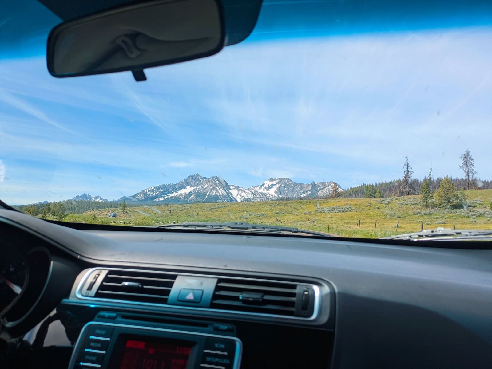 View of mountains out the windshield of a car