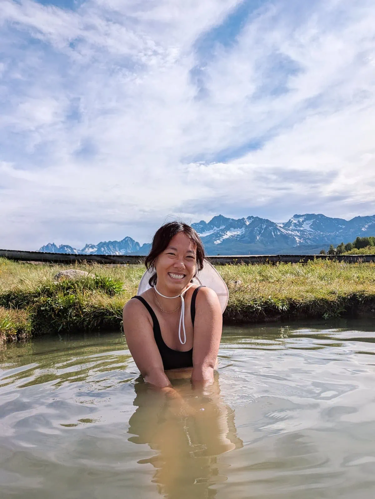 Me sitting in Valley Creek Hot Springs in Stanley with the mountains in the background